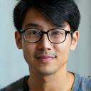 Photo of Hiroshi Nakamura, a young man with glasses and a thoughtful expression.